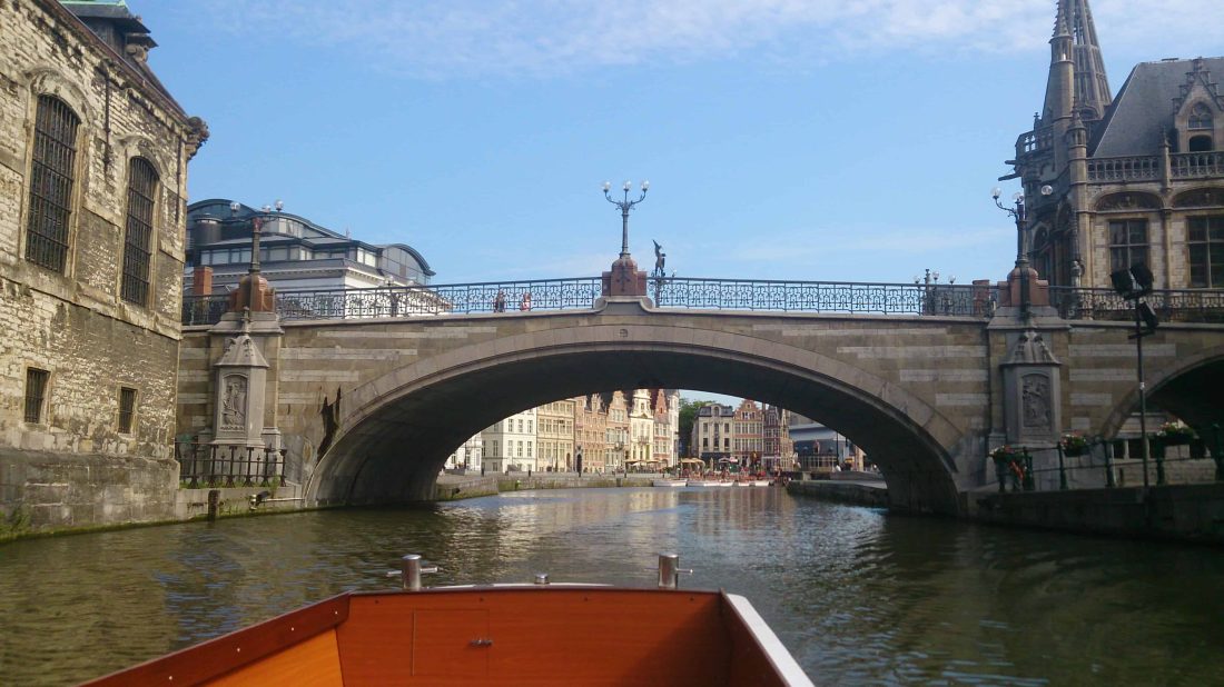 View of the water and the St. Michael's Bridge during a boat tour in the canals in Ghent