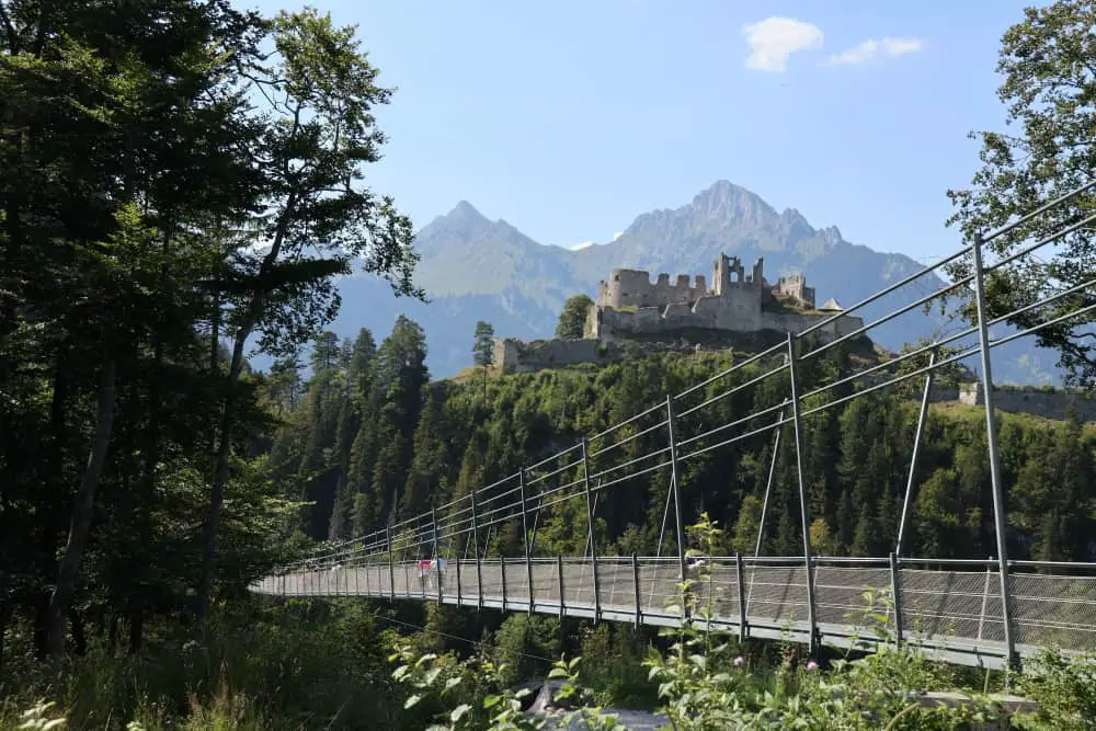 view of the highline179 with the ruin of Ehrenberg and the Austrian Alps in the background, a top thing to see in the area nearby Fussen