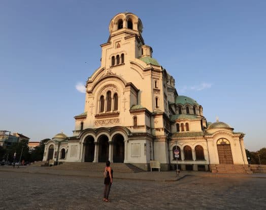 The cathedral is the landmark of Sofia, Bulgaria. Author Christina ist standing in front of the from the sunset lit church.