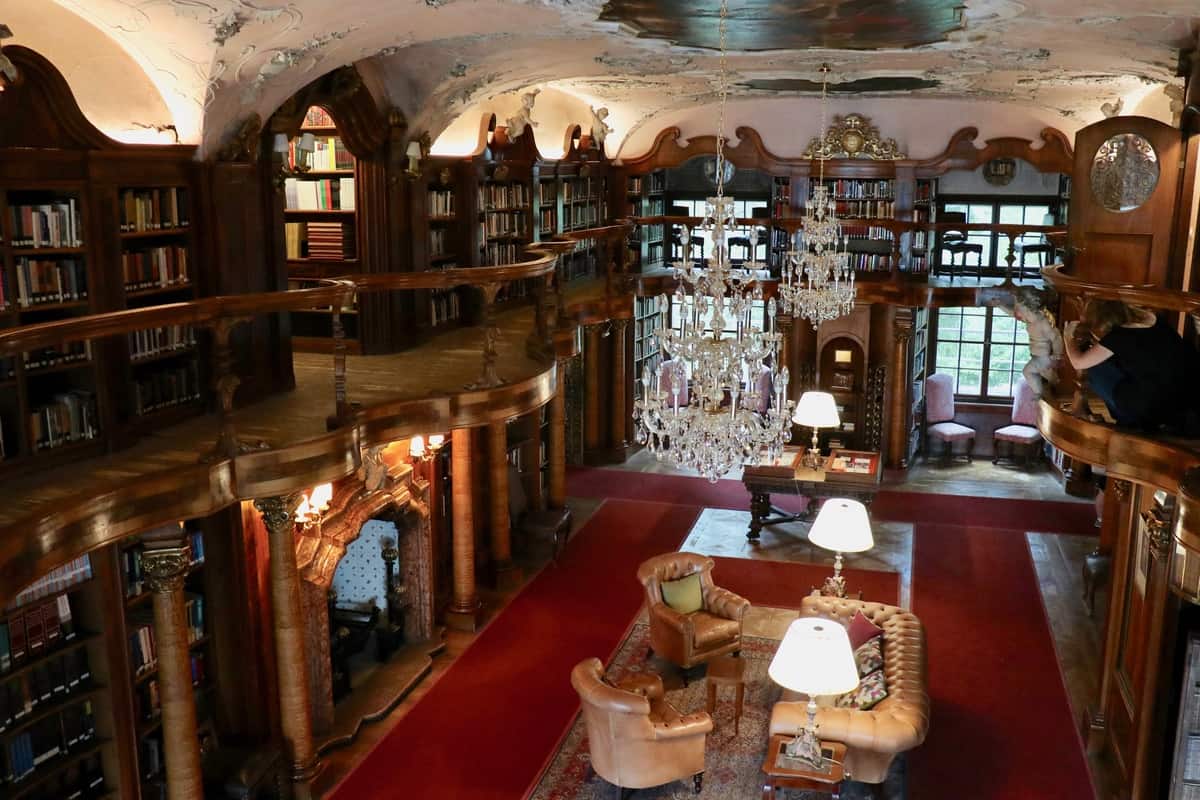 View of the richly decorated two-story high library in the Hotel Schloss Leopoldskron