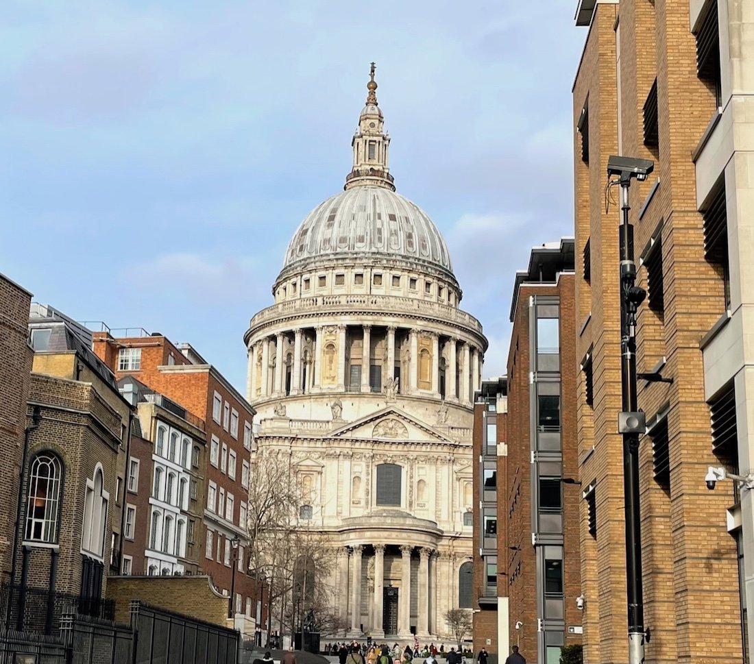 St. Peter Cathedral in London surrounded by brick buildings.