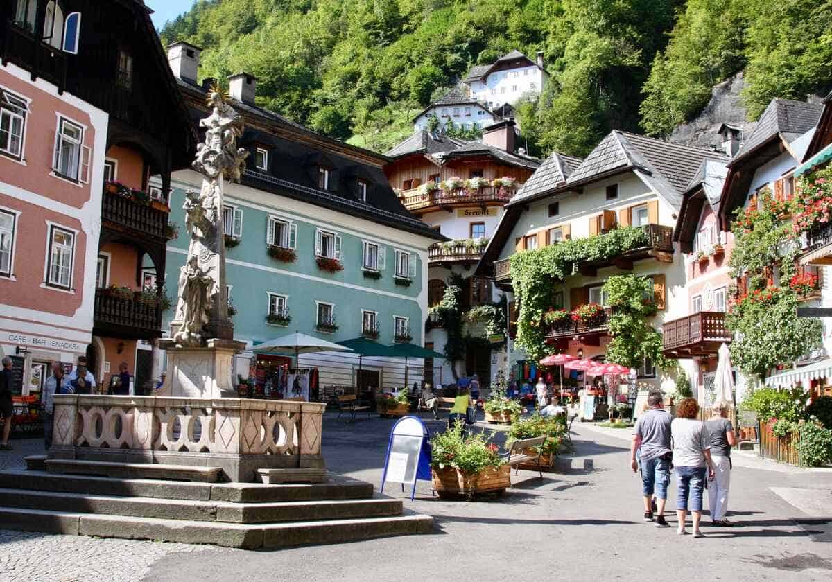 historic market place in Hallstatt with fountain and colorful houses