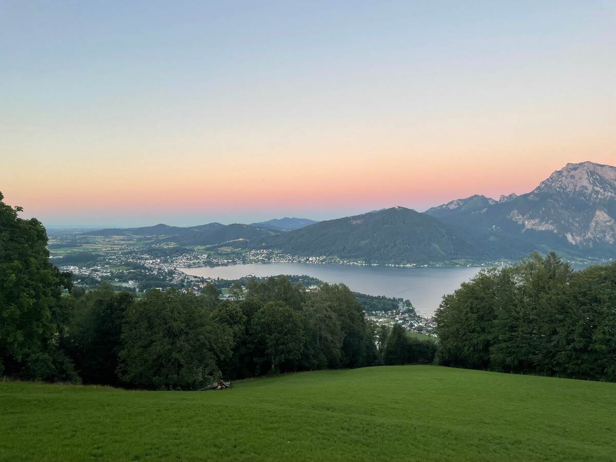 View of Lake Traunsee and Gmunden from above at sunset.