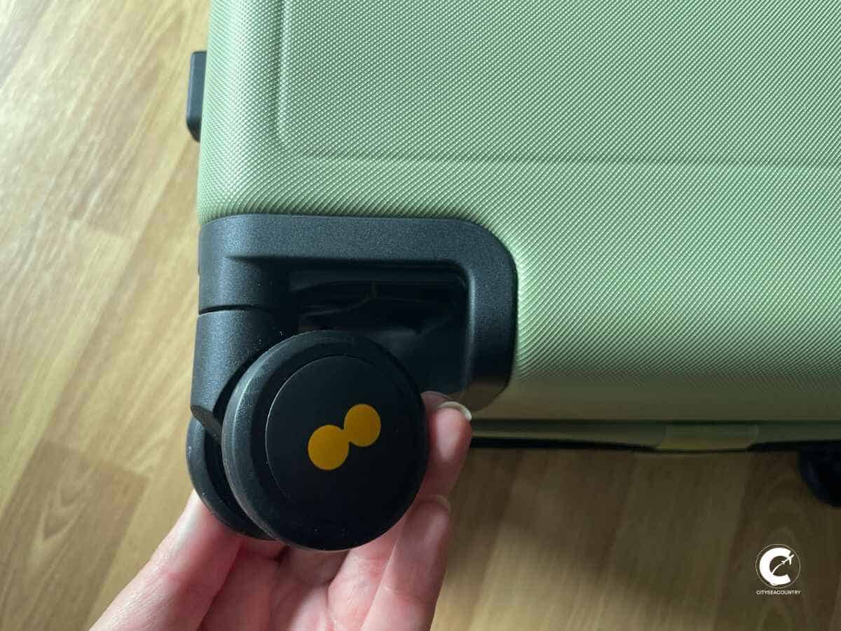 Hand holding one of the black spinner wheels including the Level8 logo.