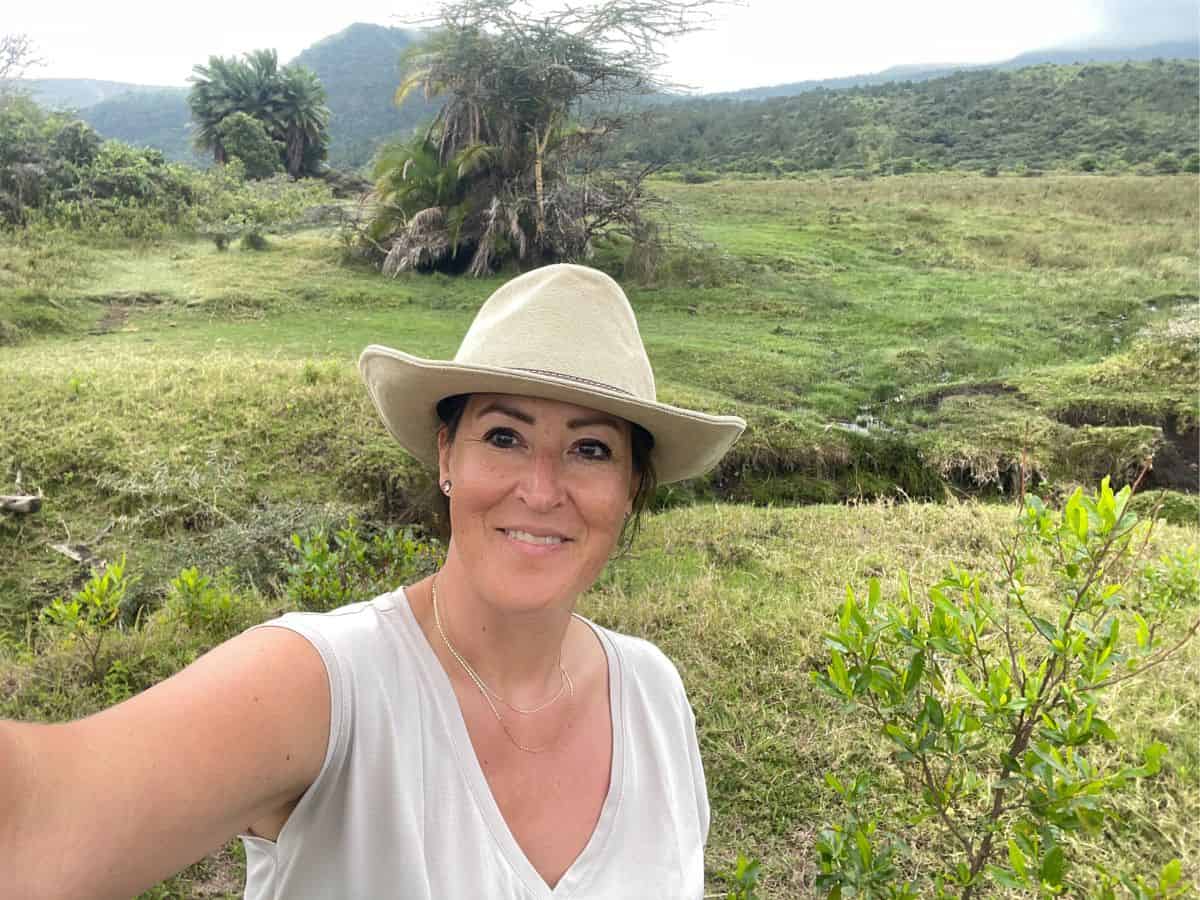 Author Christina during a walking safari in Tanzania wearing a beige hat and a beige shirt