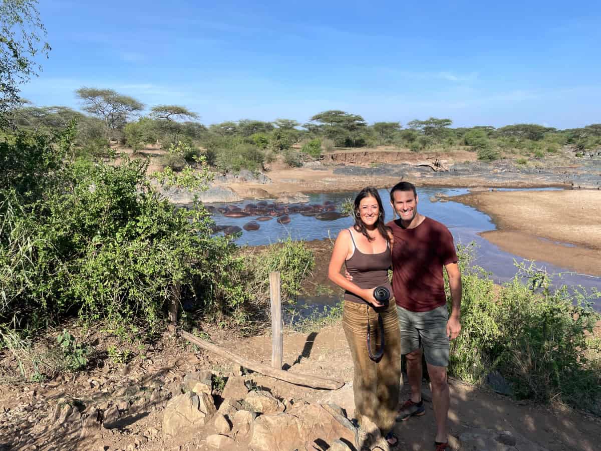 Hippo pool in the Serengeti with Christina and her partner wearing comfortable clothes suitable for long game drives.